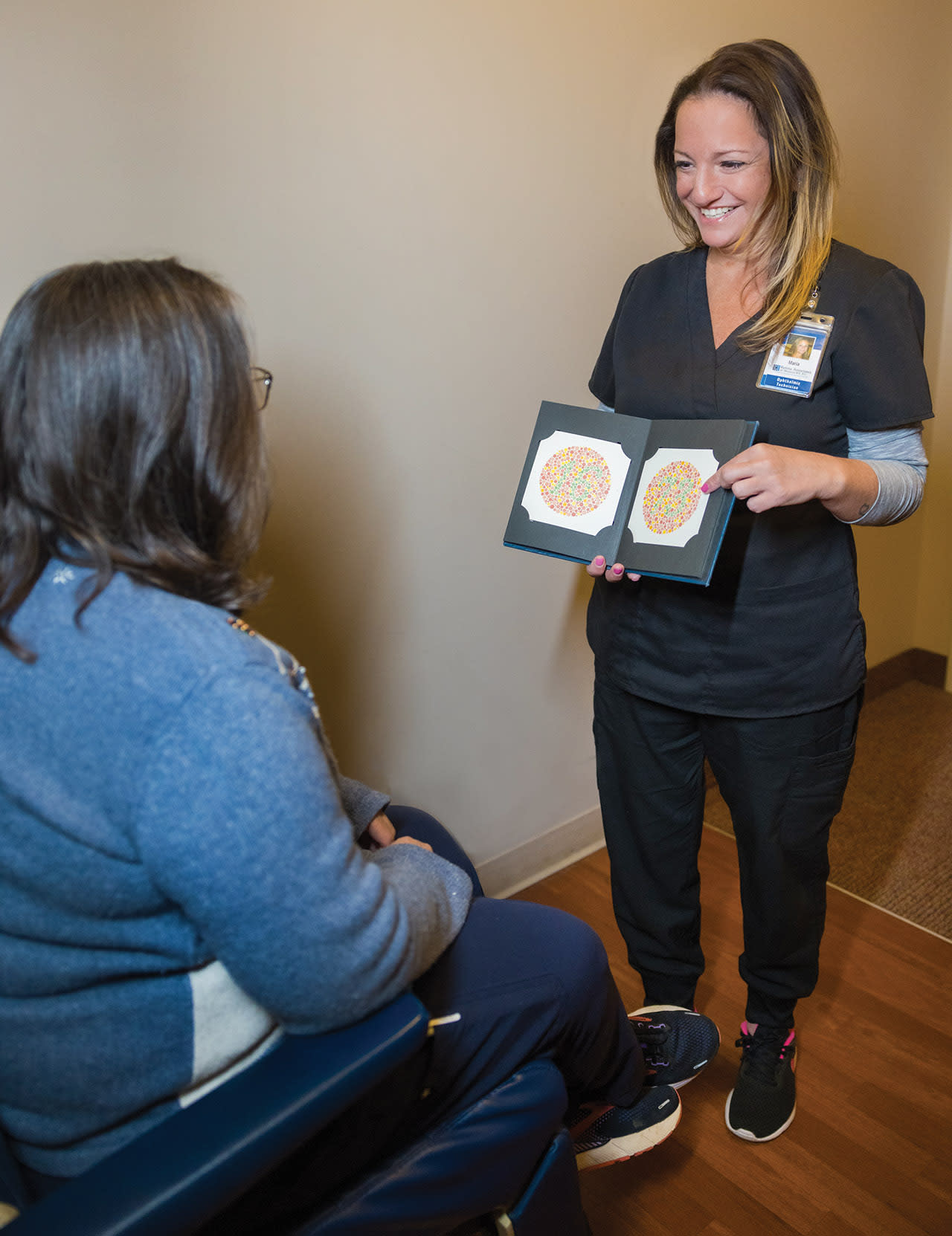 Maria Marion, ophthalmic technician, performs an Ishihara color plate test for a patient who has been taking hydroxychloroquine. Long-term use of this medication can cause ocular toxicity to various parts of the eye including the retina, which can lead to color blindness.