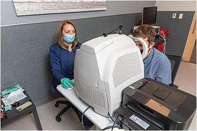 With the help of Lean practices, diagnostic testing has become more efficient. Here, Jackie Groth, imager, uses a Zeiss Cirrus OCT to image the patient’s retina.