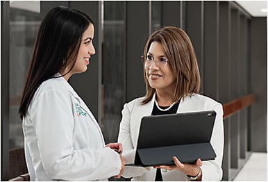 Leisa Gutierrez (left) discusses details of the onboarding program with Martha Tello.