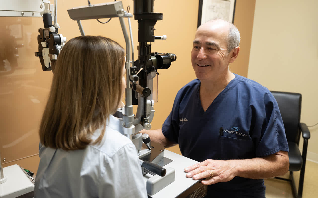 Dr. Timothy Kisla, cataract and refractive surgeon for Advanced Eye Care SC, examining a patient.