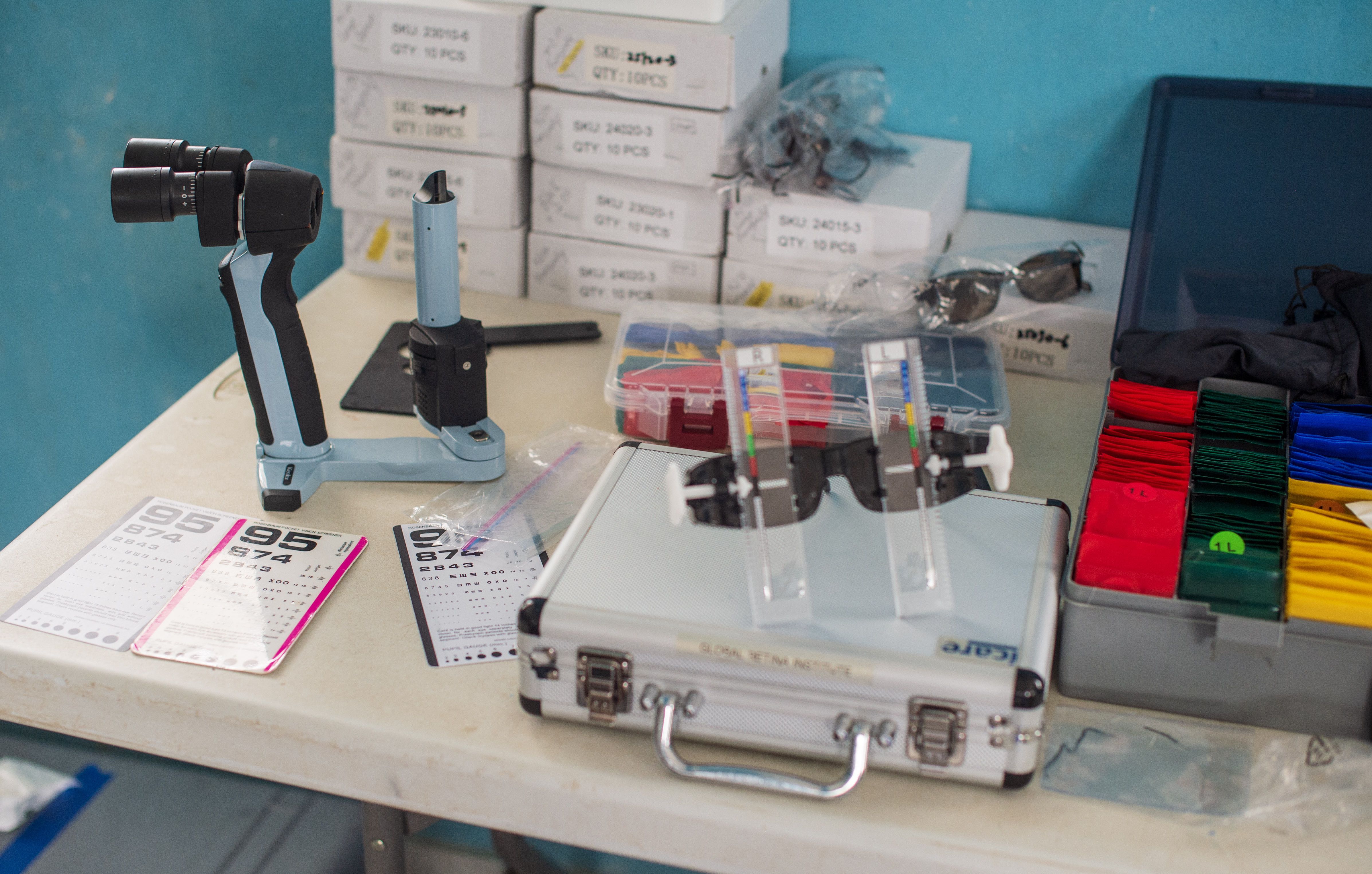 Tools that first-year medical students learn to use while on international trips with the University of Arizona College of Medicine-Phoenix: Rosenbaum Pocket Eye Vision Card, iCare Tonometer, Keeler portable slit lamp, USee self-refracting glasses and refraction kit (Global Vision 2020), and VisionSpring reading glasses in boxes. Not pictured are the Peek Acuity smartphone-based vision-check app by Peek Vision as well as a portable ultrasound.
