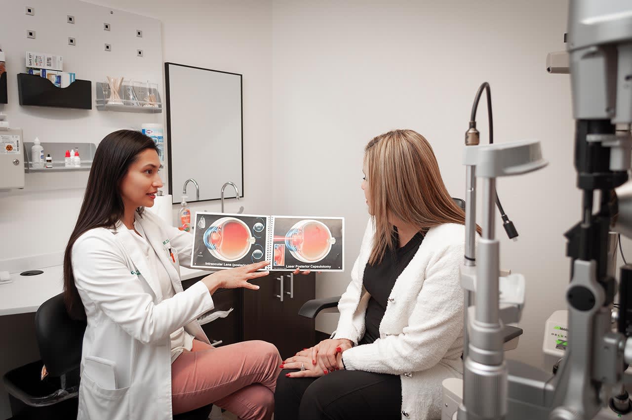 Dr. Jana Waters shows an illustrated eye book to a patient.