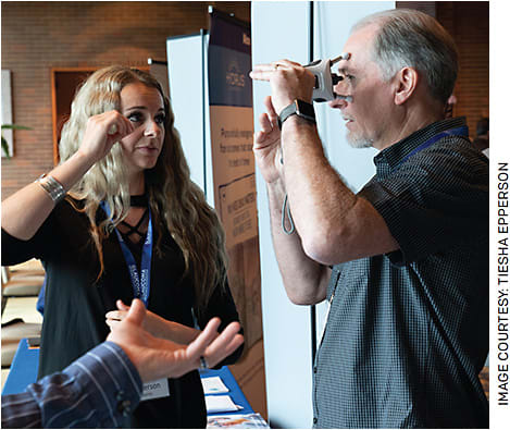 An attendee at the Glaucoma Patient Summit, sponsored by Glaucoma Research Foundation, tries out the iCare HOME2 tonometer (Icare USA).