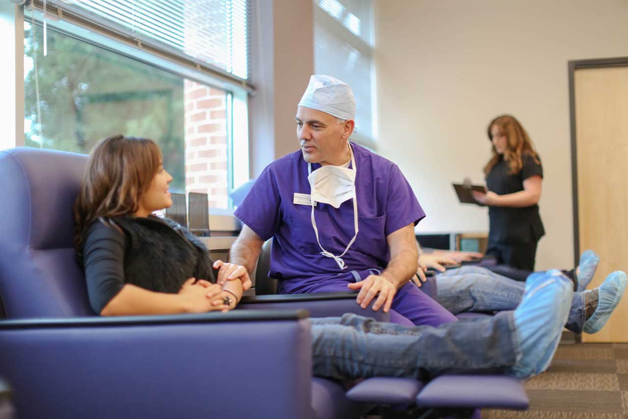 Dr. John Doane talking to a patient before a vision correction procedure.