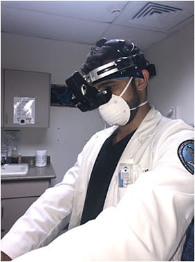 Figure 2. Ophthalmology resident at the University of Puerto Rico evaluating a patient with personal protective equipment. Image courtesy Nicole Rebollo, MD.