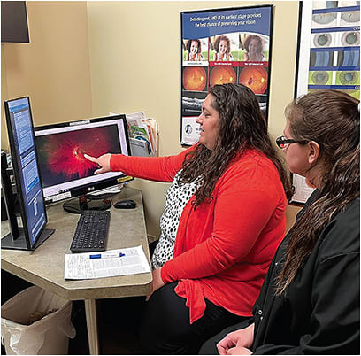 Dr. Sandra Travaglianti, a staff optometrist at Northeast Ohio Eye Surgeons, shows a patient a widefield retinal image from a recent exam. Photo courtesy of Dr. Tim Earley