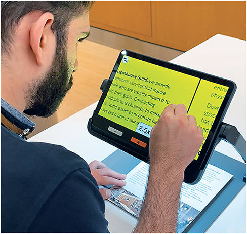 Note this patient learning how to use an electronic magnifier. Photo courtesy of Lighthouse Guild