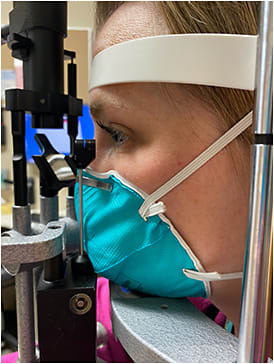 Figure 2. 3M Health Care Particulate Respirator and Surgical Mask positioned at the slit lamp.