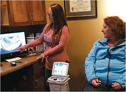 Dr. Weiss is shown back in action seeing a patient at her practice.