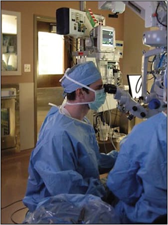 Figure 4. In the operating room, adjust the eyepieces to avoid awkward neck postures. Back and neck position while using microscope is critical. In this image, the physician’s neck is in extension. The eyepieces need to be set slightly below sitting eye height.
REPRINTED WITH PERMISSION FROM THE AMERICAN ACADEMY OF OPHTHALMOLOGY.