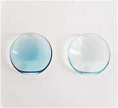 Figure 1. This translating GP progressive bifocal lens appears much darker in the standard blue color (left) than it does in the ice blue color (right).