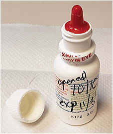 Figure 2. Opening and expiration dates must be written on solution bottles.