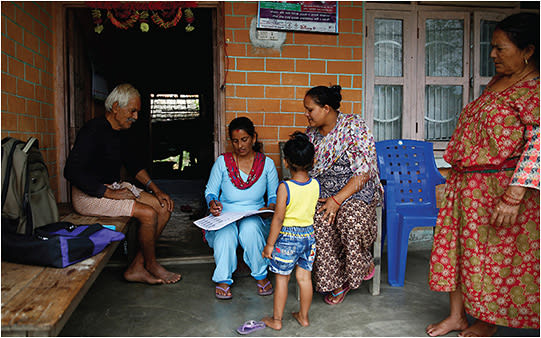 A community health worker gives care instructions to a patient.