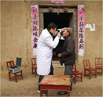 A SightLife ophthalmologist examines a patient in rural China.