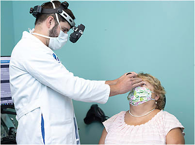 Ric France, MD, examines a patient.