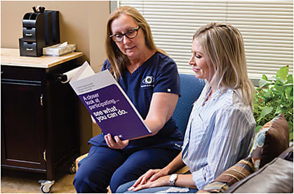 Christina Sorenson, OD (left), discusses patient participation in clinical trials.