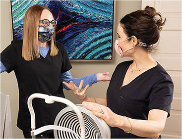 Staff education plays a large part at Periman Eye Institute. Here, Dr. Periman (right) discusses test results with Christeen DeNeui, COA, office administrator, clinical trial coordinator, and ophthalmic assistant.