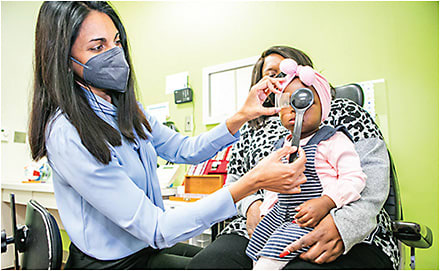 Dr. Bohra performs a prism and cover test to measure strabismus.