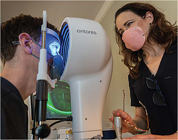 As part of the dry eye workup, Dr. Periman (right) uses a multifunctional corneal topographer (Antares).