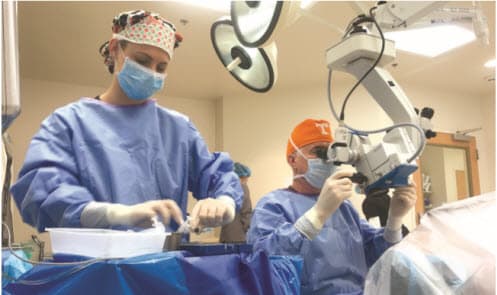 Larry Patterson, MD, medical director of Eye Centers of Tennessee, with assistance from scrub tech Sarah Wilson, performs cataract surgery on an awake-and-aware patient.