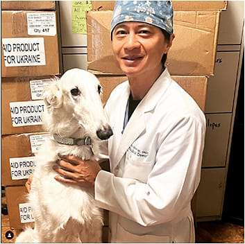 Dr. Chynn and his dog (and office mascot) Tolstoy stand next to the units of BloodStop prior to delivering them to Ukraine. Image courtesy: Robert Buchelli, patient coordinator, Park Avenue LASEK