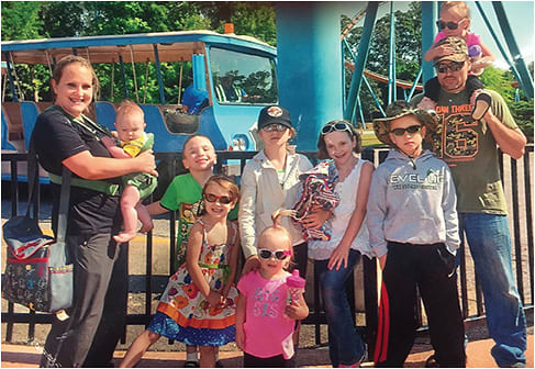 Staff Sgt. David Payton with wife Heather, and his large family out for a day of fun at a Six Flags.