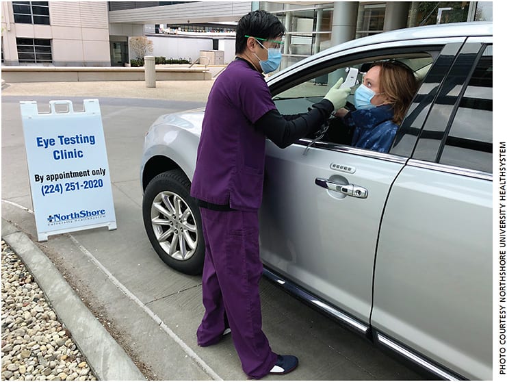 Ophthalmic technician Rommel Yap demonstrates the curbside testing at the parking lot of NorthShore University HealthSystem with the help of another technician.