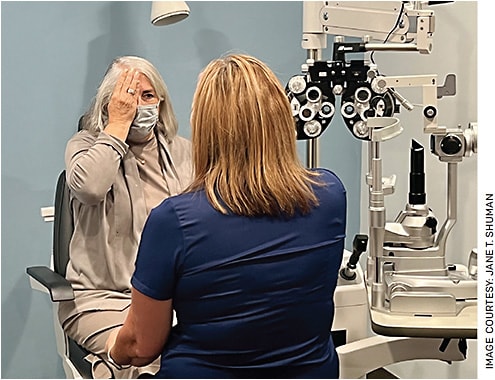 Jane T. Shuman, as the trainer/patient (left), observing the technician’s technique performing confrontation visual fields.