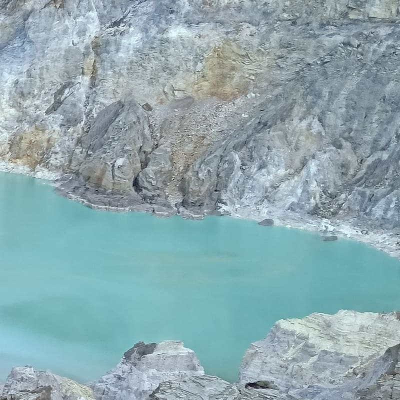 Breathtaking turquoise sulfur lake at Ijen crater with morning mist