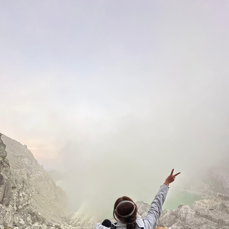 Mystical blue flames through misty clouds at Ijen crater