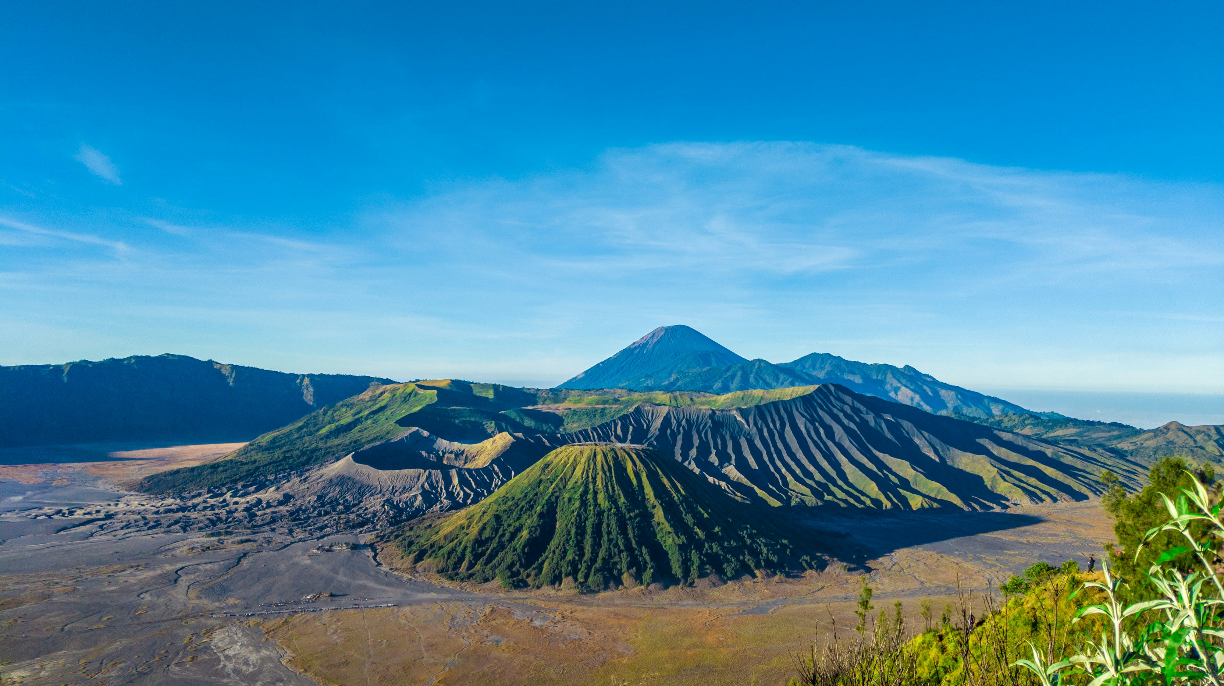 Panoramic sunrise view over Mount Bromo with volcanic landscape