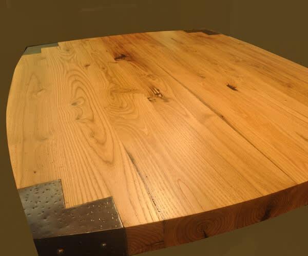 4" thick antique-chestnut premium wide plank countertop. Custom blackened-steel corner caps and a Marine Oil Finish.