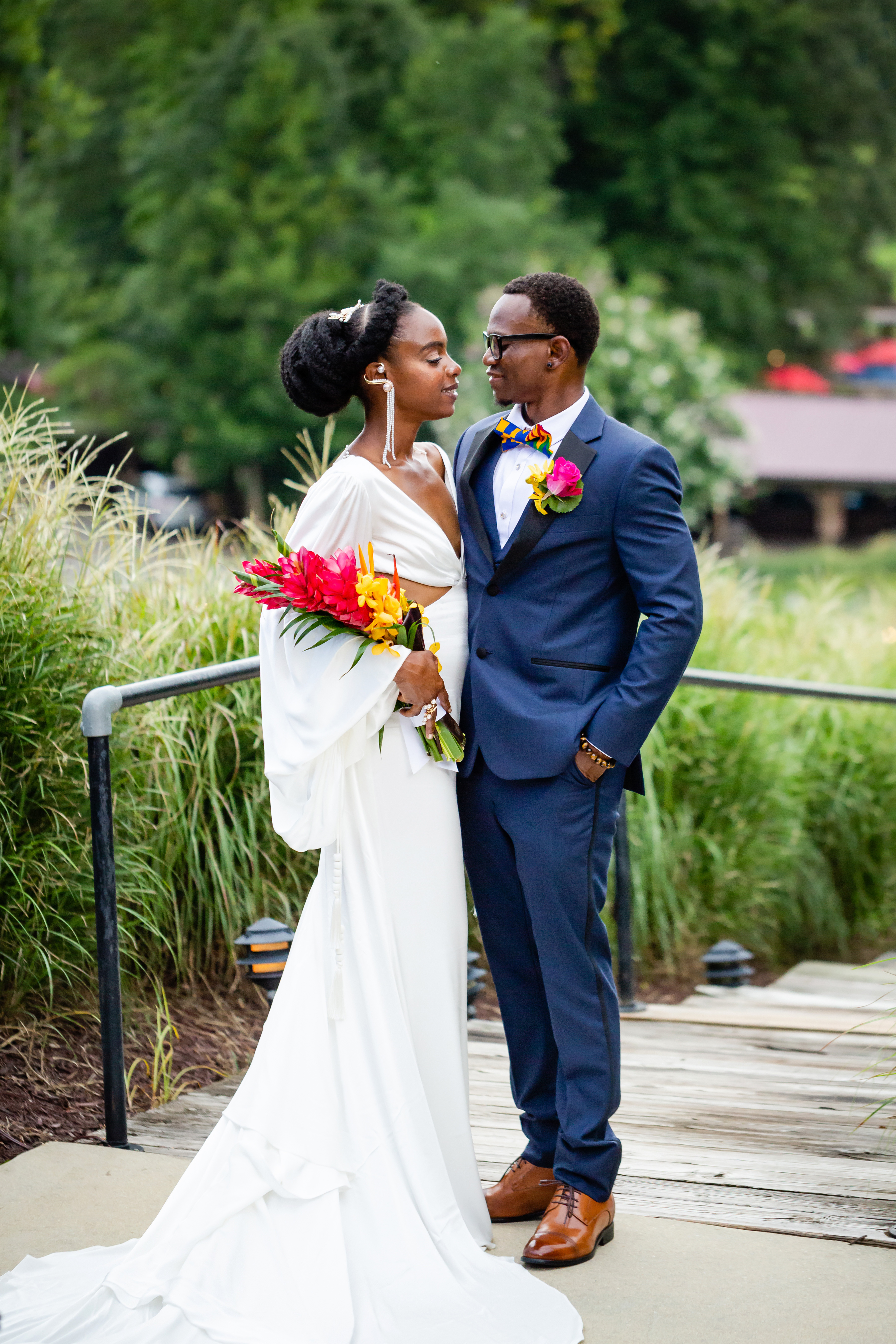 Newly wed couple looking at each other for photo shoot.