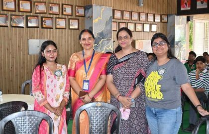Four alumnae of Sunbeam School Ballia standing together in the hall during the meet, wearing the event’s badges.