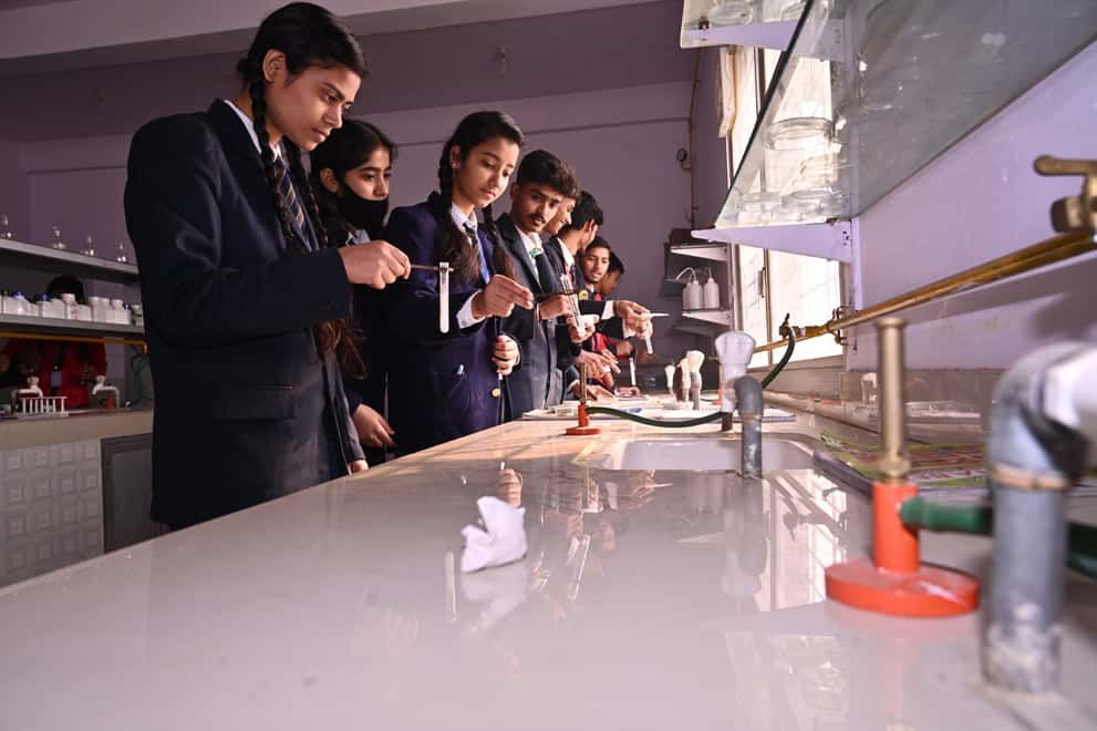 Students of Sunbeam School Ballia working along the chemistry bench