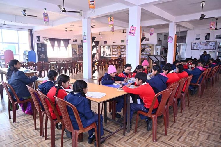 Students of Sunbeam School Ballia reading and working at tables in the Nalanda Library.