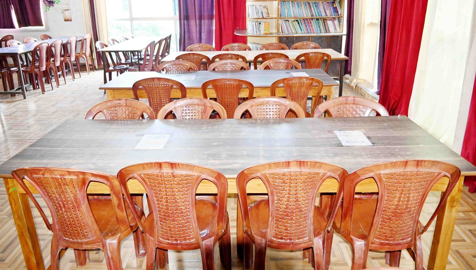 The Nalanda Library at Sunbeam School Ballia, its shelves signed by subject and its reading tables set out beneath them.