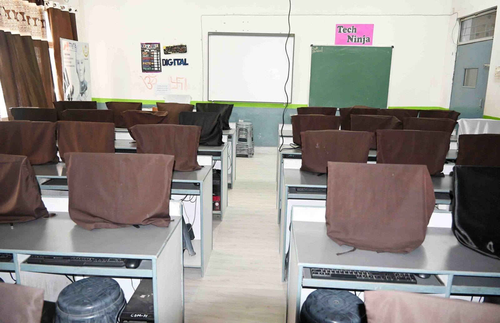 A computer laboratory at Sunbeam School Ballia, rows of workstations facing an interactive board.
