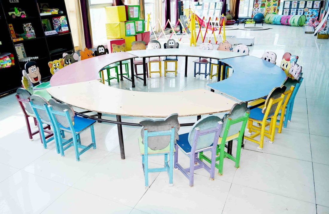 The curved activity tables and toy shelves of the early-years activity room at Sunbeam School Ballia