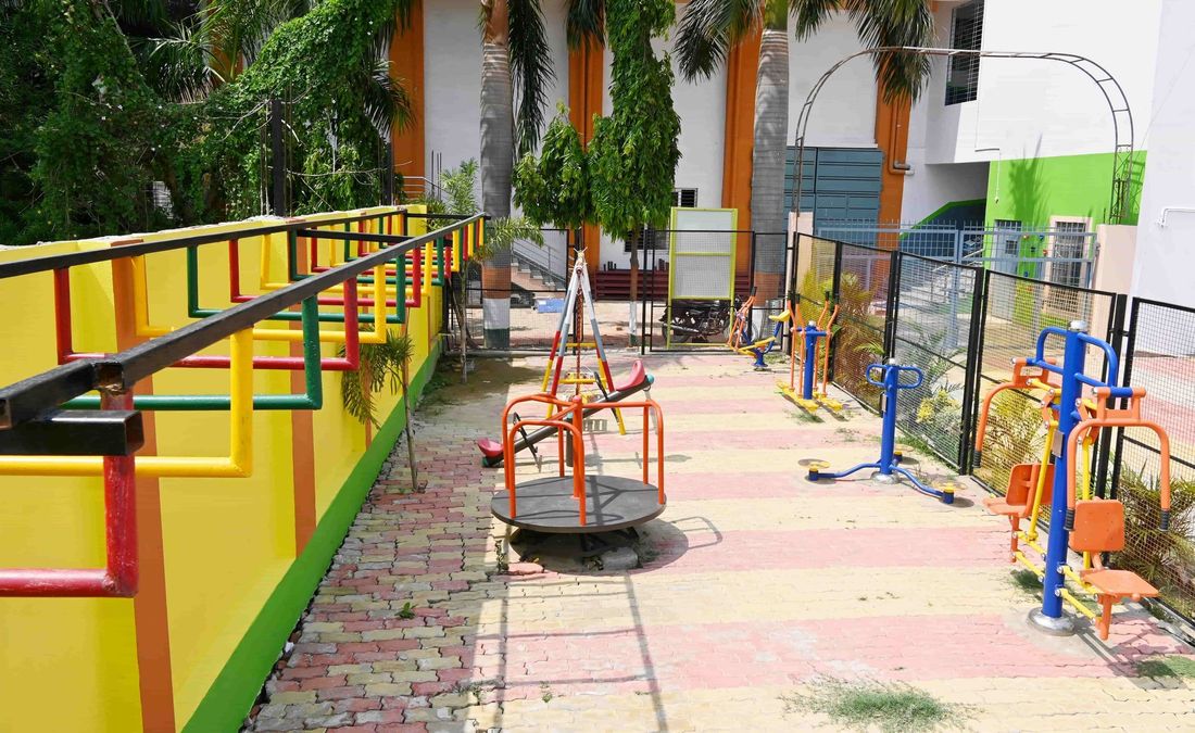 The early-years kids park at Sunbeam School Ballia — a merry-go-round, seesaw and climbing rails beside the junior block