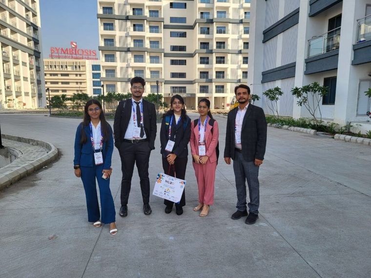 Sunbeam School Ballia students with the school flag at the IMUN summit in Indore — photograph 4 of 4