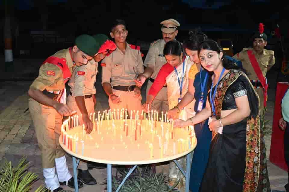 NCC cadets and staff of Sunbeam School Ballia lighting candles set out on a table after dark, at the school’s Kargil Vijay Diwas observance.