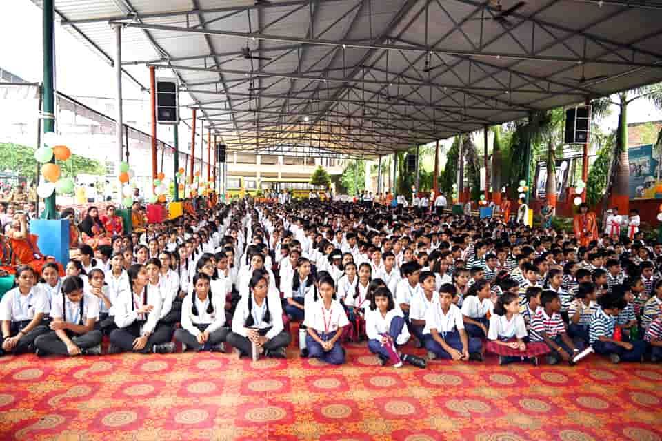 The whole school of Sunbeam School Ballia seated under the canopy for an assembly, staff along the side