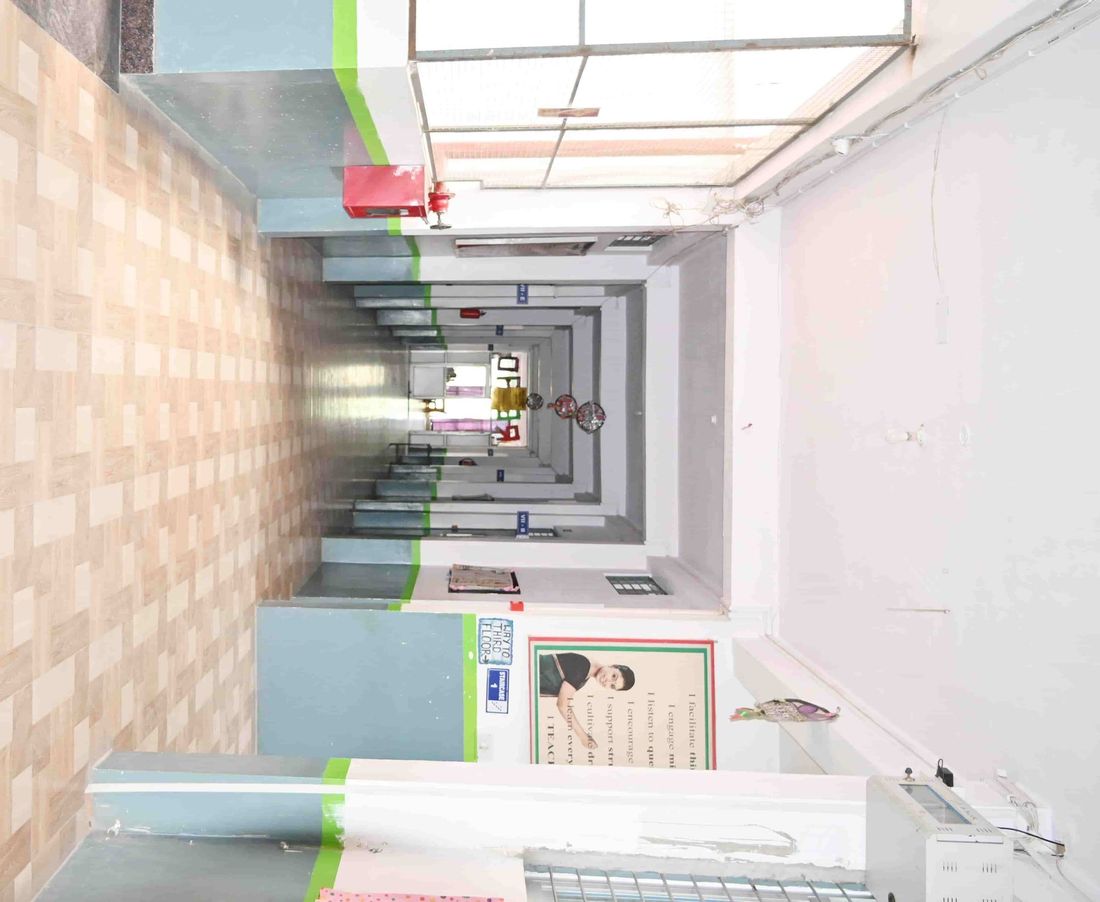 A corridor at Sunbeam School Ballia, its classroom doors running the length of the block