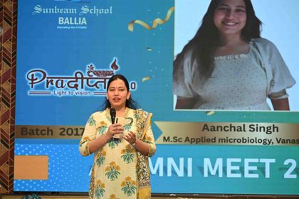 An alumna of the 2017 batch speaking at Pradiptam 2.0, her name and degree on the screen behind her.