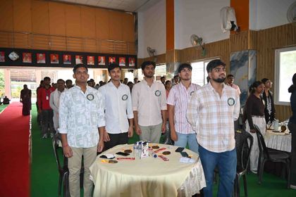 Alumni of Sunbeam School Ballia standing at their tables, their medallions and an Alumni Meet 2026–27 card in front of them.