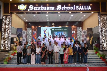 Alumni and staff of Sunbeam School Ballia on the school steps at the close of Pradiptam 2.0, the stage behind them.