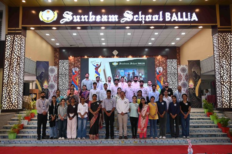 Alumni and staff of Sunbeam School Ballia on the school steps at the close of Pradiptam 2.0, the stage behind them.