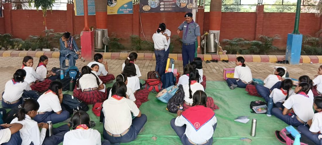 Guides of Sunbeam School Ballia seated in a circle receiving instruction.