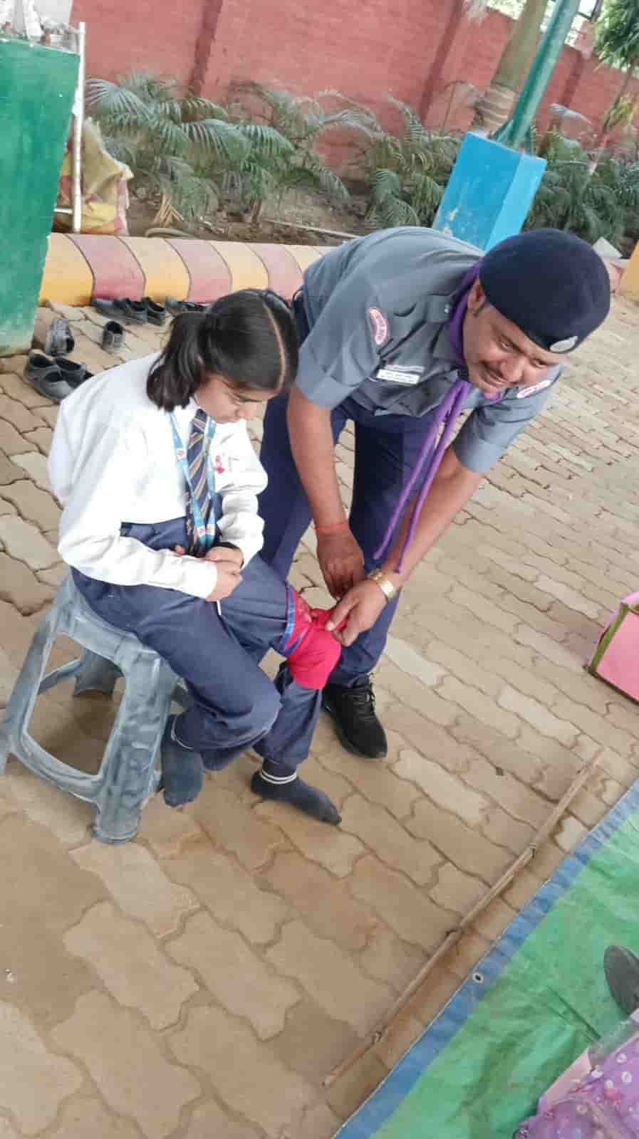 Scouts of Sunbeam School Ballia practising first aid on the ground, bandaging under supervision.